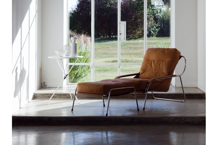 The Maggiolina chair features a stainless steel tubular frame and leather upholstery.